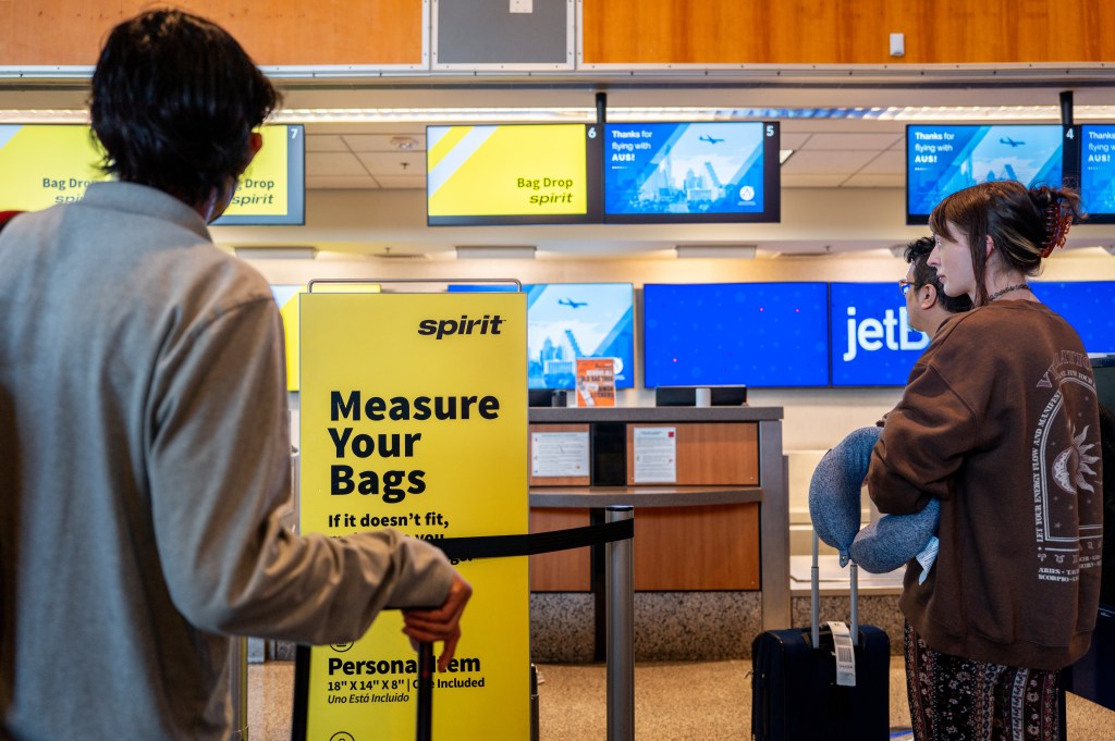 AUSTIN, TEXAS - APRIL 10: Customers wait in line to drop off luggage at a Spirit Airlines check-in counter at Austin-Bergstrom International Airport on April 10, 2024 in Austin, Texas.  Spirit Airlines has reported that it will delay aircraft purchases and lay off pilots as the company continues to struggle with financial difficulties.  The move comes after a federal judge blocked a proposed deal that would have allowed the airline to be acquired by JetBlue.