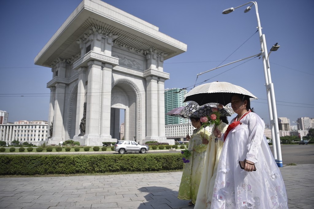 Pedestrians cross the Arc de Triomphe in Pyongyang on August 15, 2024, as North Korea marks its 79th National Liberation Day, commemorating the end of Japanese colonial rule at the end of World War II